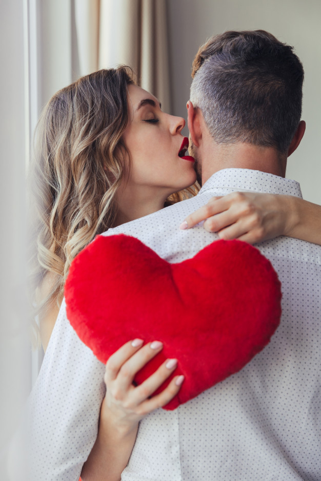 caucasian,boyfriend,girlfriend,hold,wife,indoor,lover,celebrating,dating,romance,relationship,concept,greeting,lovely,day,hug,happiness,pillow,emotion,young,together,female,romantic,valentines,person,shape,couple,event,smile,valentines day,home,girl,woman,heart,people