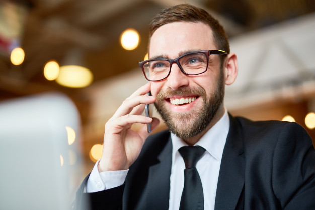 answering,formalwear,businessperson,discussing,using,bearded,cheerful,handsome,smiling,calling,blurred,sharing,eyeglasses,portrait,ideas,smart,manager,entrepreneur,young,talking,project,working,suit,communication,businessman,smartphone,happy,mobile,man,phone,business