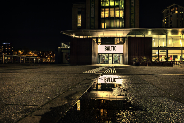 architecture,baltic,buildings,city,dark,downtown,evening,illuminated,light streaks,lights,modern,night,nightlife,outdoors,pavement,reflections,signage,square,urban,water,wet