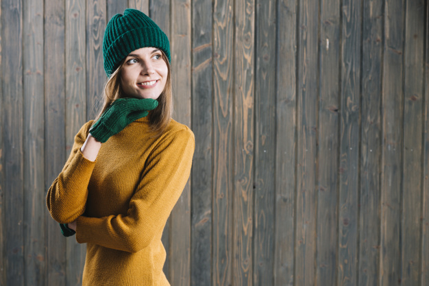 background,winter,hand,woman,green,green background,hair,space,face,color,happy,wall,clothes,yellow,person,yellow background,colorful background,hat,cap,brown,lady,dark background,wooden,brown background,female,woman face,dark,young,wooden background,warm,colourful background,sweater,view,beautiful,portrait,bright,arm,colourful,beauty woman,woman hair,wool,soft background,gloves,soft,horizontal,pretty,smiling,copy,wear,looking,jumper,knitted,side,cheerful,comfortable,pullover,blond,thoughtful,away,chin,side view,indoors,copy space,pensive,looking away