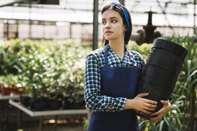flower,people,blue,black,garden,person,organic,agriculture,farmer,pot,female,young,professional,botanical,beautiful,apron,gardening,lifestyle,beauty woman,nursery