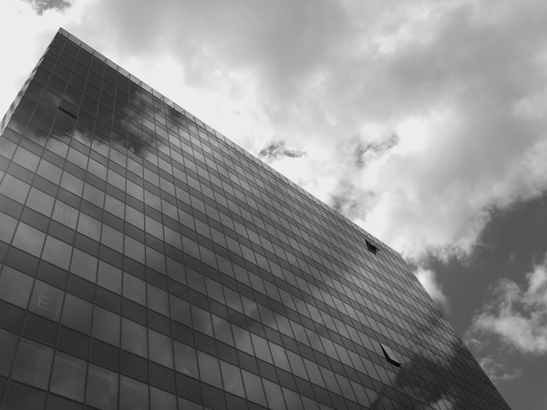 windows,skyscraper,sky,perspective,monochrome,low angle photography,glass windows,glass,exterior,clouds,building exterior,building,black-and-white,architecture