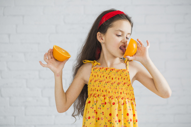 food,people,house,home,fruit,cute,orange,wall,kid,child,white,yellow,person,dress,cross,mouth,healthy,brick,eat,healthy food