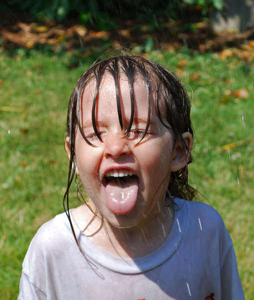 summer,water,sprinkler,girl,child,children,play,playing,fun,joy,hose,splash,young,tongue,summertime,hot,weather,heat