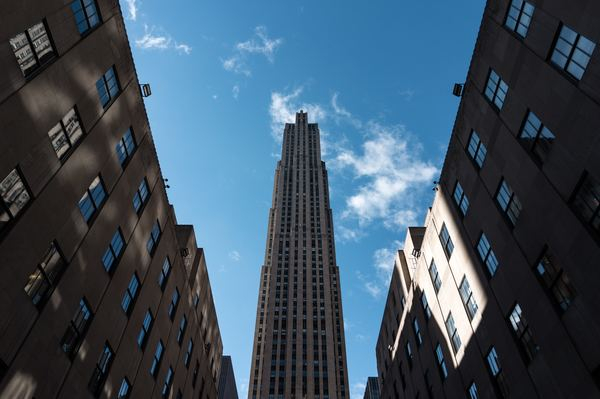 city,building,architecture,architecture,building,light,nyc,city,building,building,skyscraper,tower,rockefeller center,sky,window,facade,architetcure,structure,blue sky,low angle,looking up