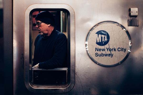 human-centered,man,face,jerry,wallpaper,light,city,street,new york,person,man,guy,male,transit,subway,window,hat,beanie,glasses,spectacles,train