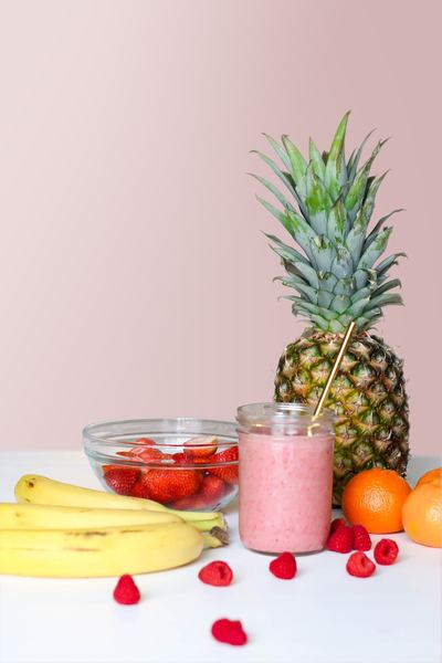 wellness,food,healthy,drink,food,fruit,card,food,table,pineapple,leaves,fruit,smoothie,pink,juice,glass,jar,straw,gold,banana,strawberries,free pictures