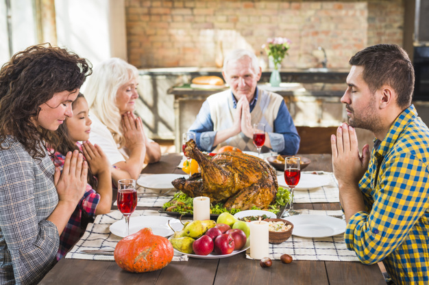 food,family,man,thanksgiving,table,home,fruit,chicken,celebration,holiday,mother,child,couple,drink,candle,plate,vegetable,dinner,father