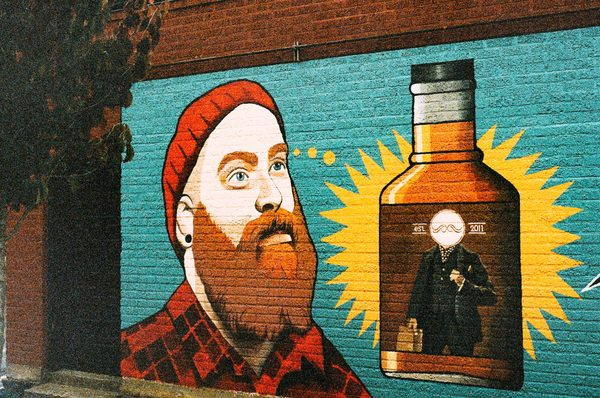 wall,paint,graffiti,man,orange,beard,hat,toque,plaid,hipster,alcohol,booze,whiskey