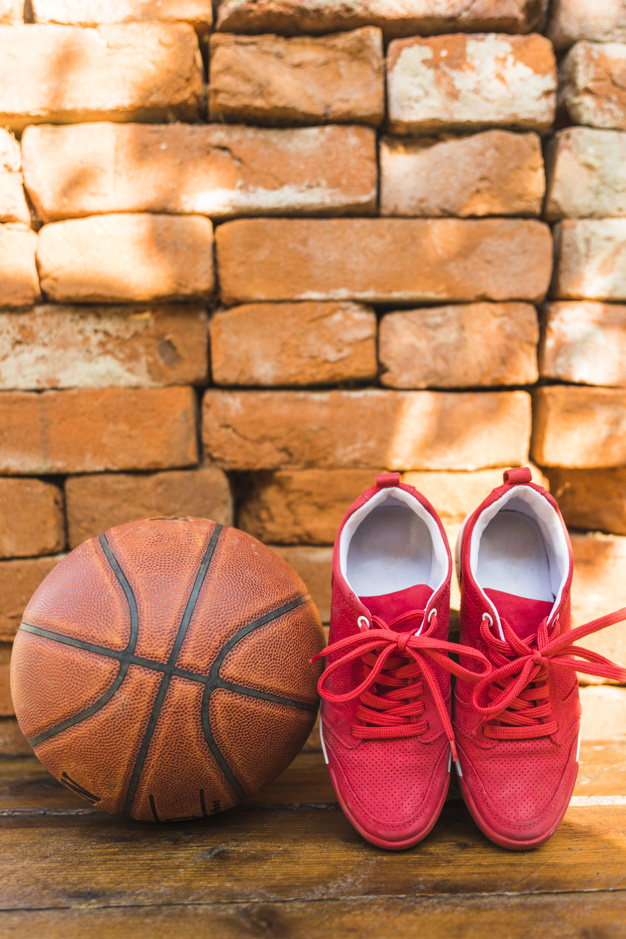wood,circle,sport,table,red,wall,basketball,game,shape,shoes,desk,round,ball,brick,brown,old,shadow,wooden,brick wall