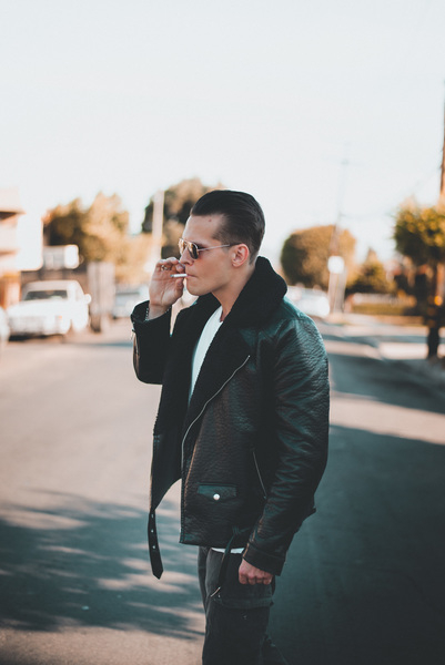 black leather jacket,car,cigarette,daytime,fashion,hair,landscape,man,outdoors,person,photoshoot,road,side view,smoking,street,style,sunglasses,trees,urban,wear,young,young man,Free Stock Photo