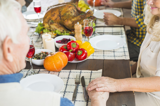 food,hand,family,man,thanksgiving,table,home,chicken,celebration,holiday,couple,drink,candle,plate,vegetable,pumpkin,dinner,old,grey