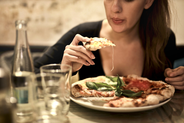 woman,pizza,food,restuarant,eat,dinner,drink,girl,italian,knife,meal,plate,tomato,wine