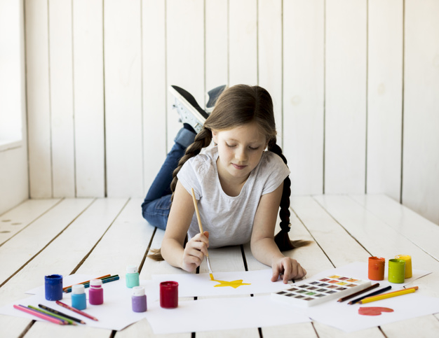 one,innocence,indoors,lying,hardwood,multicolored,little,casual,hold,childhood,artwork,hobby,artistic,portrait,painter,artist,female,craft,draw,paintbrush,creativity,wooden,floor,painting,drawing,creative,bottle,person,yellow,white,pencil,colorful,kid,wall,color,art,cute,brush,home,paint,girl,paper,star,wood,people,watercolor