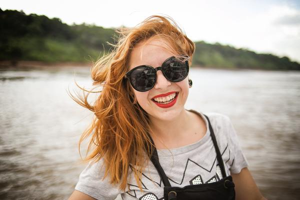 woman,sunglasses,smiling,smile,happy,red hair,windy,boat,lake,river,nature,lipstick