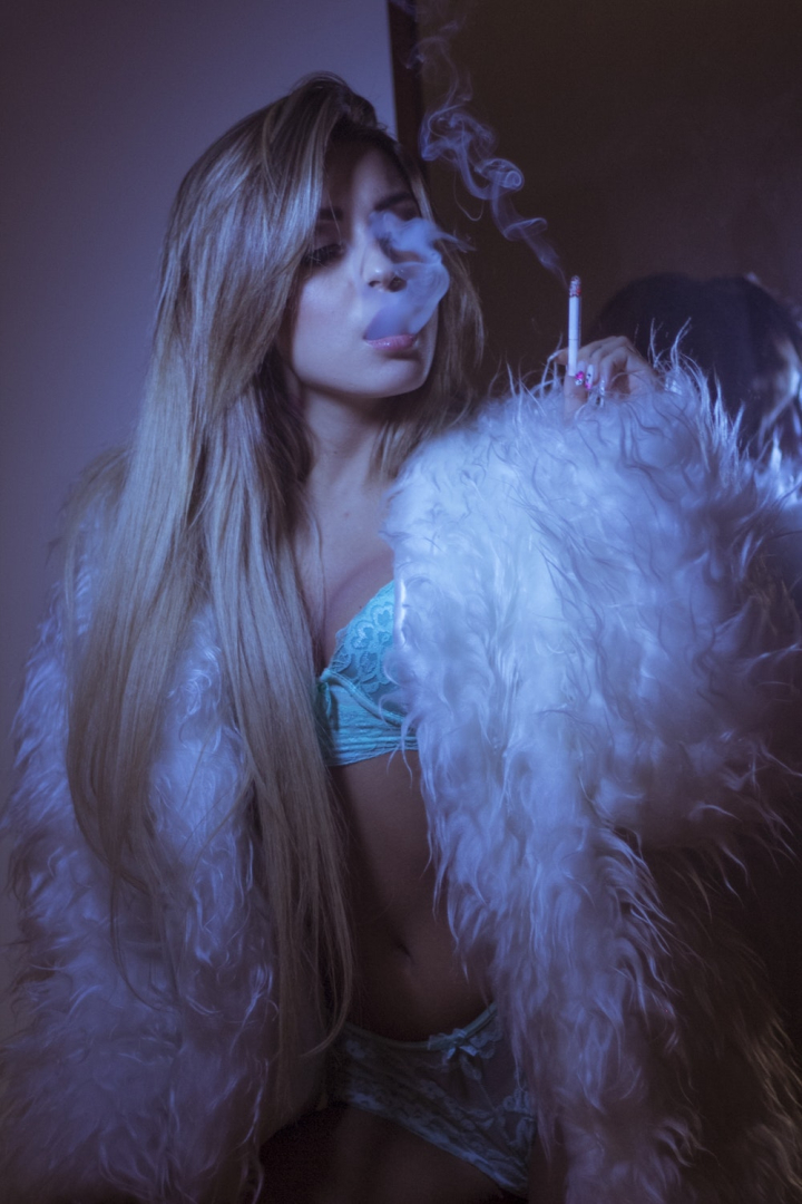 Free: Photo of Woman in Lingerie and Faux Fur Coat Smoking Cigarette 