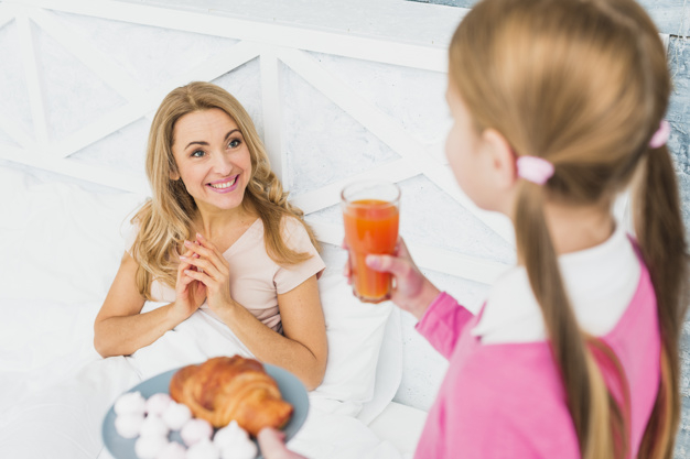 indoors,side view,blond,little,cheerful,daughter,side,casual,standing,smiling,pretty,horizontal,parent,adult,holding,giving,beverage,croissant,happy kids,beauty woman,cute girl,lifestyle,meal,beautiful,view,fresh,female,nutrition,morning,surprise,happy family,dessert,bed,plate,sweet,breakfast,juice,drink,glass,happy holidays,present,child,mother,holiday,kid,happy,orange,cute,home,girl,woman,family,gift,love,food