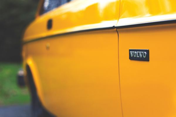 color,colorful,art,yellow,wall,door,yellow,building,architecture,volvo,logo,brand,yellow,car,door,panel,automobile,auto,shiny,automotive,paintwork