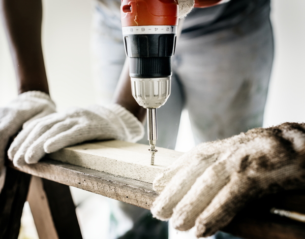 builder,carpenter,close-up,craftsman,drill,electric drill,equipment,fixing,furniture,gloves,helping,home,home improvement,house,indoors,plank,protective,renovation,repair,repairing,service,skill,support,teamwork,together,tool,wood,wooden,woodwork,workbench,working,Free Stock Photo