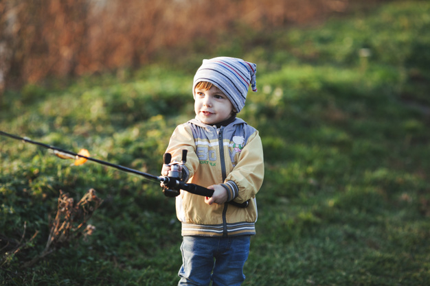 people,line,nature,sport,fish,cute,grass,kid,child,person,boy,children day,fishing,tool,portrait,lifestyle,day,weekend,hobby,reel,holding,equipment,standing,outdoors,childhood,leisure,hold,front,casual,rod,catch,angler,tackle,angling,selective,headwear,freshwater,waistup