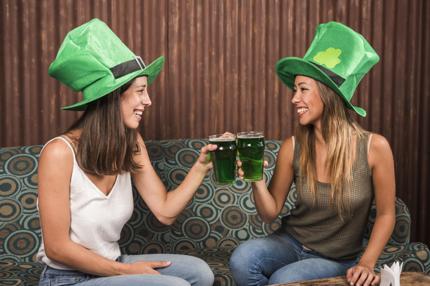 clanging,settee,st,ale,side view,patricks,pleasure,cheerful,side,leprechaun,saint,tradition,horizontal,drunk,irish,drinking,beverage,st patricks day,lucky,celtic,season,day,sitting,festive,happiness,view,young,together,female,traditional,alcohol,womens day,friend,friendship,lady,sofa,symbol,fun,hat,drink,glass,decoration,happy holidays,glasses,room,women,holiday,happy,celebration,spring,beer,green,woman,party