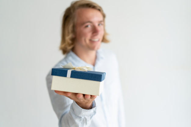 love,gift,hand,man,box,hair,gift box,happy,shirt,person,present,white,studio,romantic,young,holding hands,portrait,focus