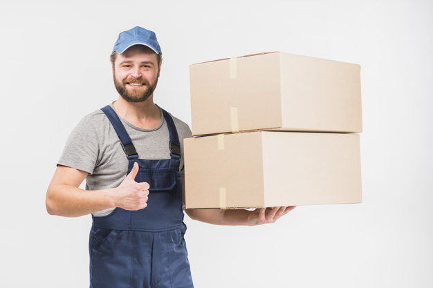 looking at camera,studio shot,showing,carrying,overall,brunette,cheerful,casual,handsome,friendly,stack,standing,looking,big,smiling,occupation,horizontal,parcel,shot,adult,holding,thumb up,courier,guy,carton,delivery man,gesture,male,positive,thumb,cardboard,packaging box,up,order,holding hands,background white,cool,boxes,professional,uniform,young,thumbs up,light background,studio,cap,package,service,background blue,beard,worker,job,like,person,white,clothes,happy,white background,delivery,blue,box,man,camera,light,hand,blue background,background