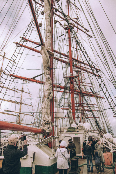 clouds,daytime,mast,outdoors,people,ropes,sail,ship,steel,tourist,transportation system,watercraft