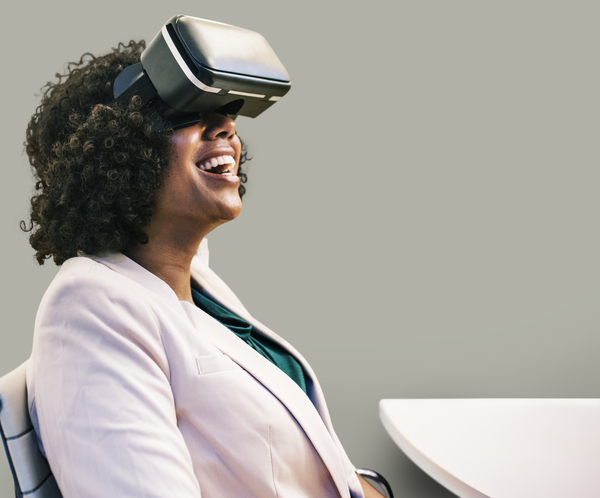 3d,VR,african american,afro,american,amused,amusement,black,businesswoman,cheerful,device,digital,enjoying,enjoyment,entertainment,european,experience,fun,funny,goggles,good time,gray,happy,headset,indoors,innovation,laugh
