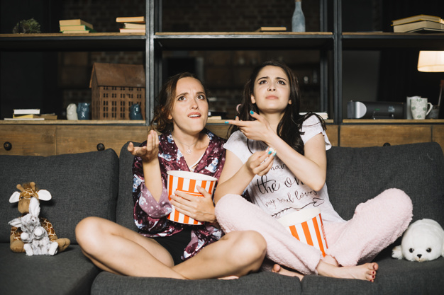 people,hand,film,room,tv,movie,friends,modern,interior,media,living room,eat,sofa,toy,model,popcorn,television,shelf,female,young