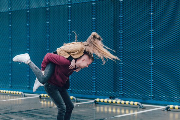 action,adult,couple,fashion,fun,hair,happiness,happy,hug,leisure,love,man,motion,outdoors,parking lot,people,piggyback ride,portrait,recreation,shoes,togetherness,wear,woman,Free Stock Photo