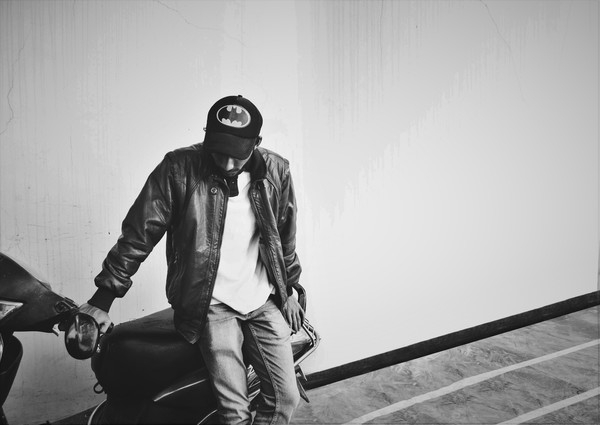 alone,background,black and white,cap,fashion,jacket,jeans,leather,man,moped,motor scooter,outdoors,person,t-shirt,tiles,wall,wear,wearing,young