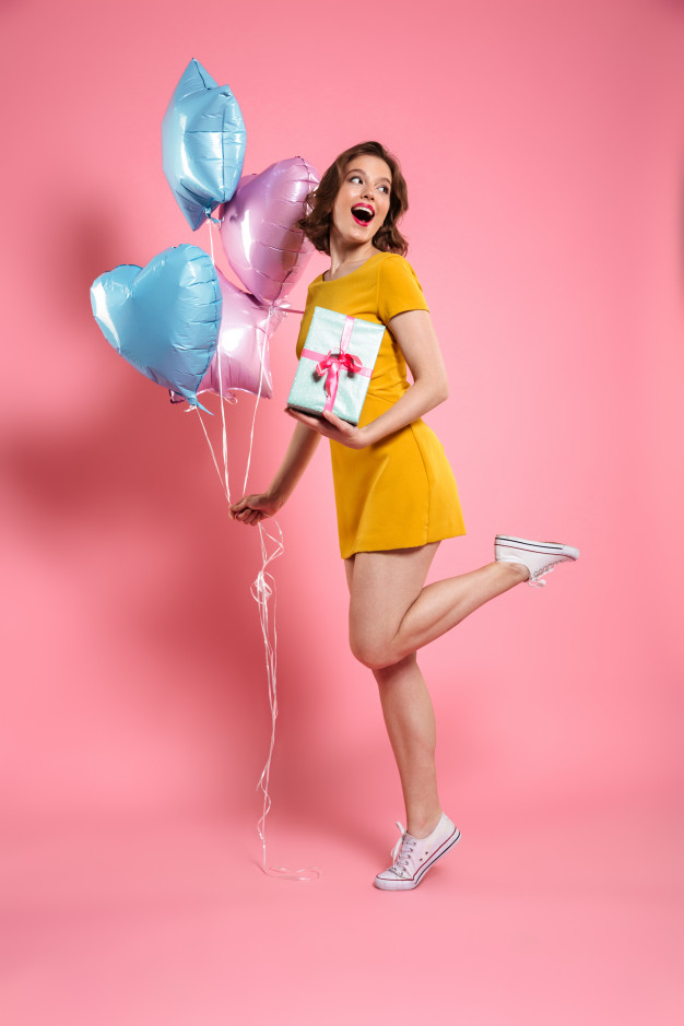 overjoyed,aside,toothy,caucasian,charming,length,posing,playful,attractive,cheerful,full,emotional,casual,standing,pretty,adult,holding,leg,positive,arm,young,female,youth,lady,balloons,dress,present,elegant,makeup,happy,girl,box,fashion,woman,gift,birthday