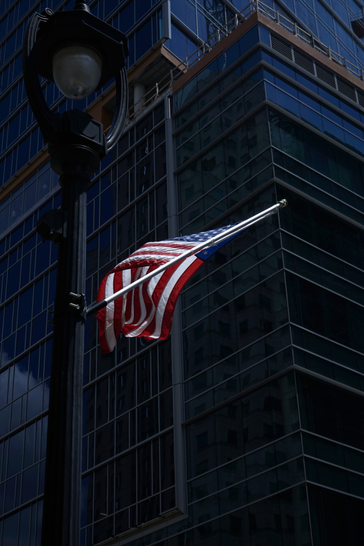 american flag,breeze,building,city,country,downtown,flag,hanging,high rise,high-rise,identity,low angle photography,low angle shot,modern,nation,north carolina,office,outdoors,patriotism,skyscraper,symbol,tallest,tower,united states of america,urban,usa,wind,windy