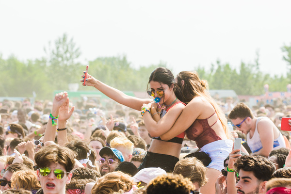 arms raised,best friends,concert,crowd,embracing,enjoyment,festival,friendship,fun,girl,group,happiness,happy,hugging,joy,leisure,music,outdoors,party,people,recreation,summer,sunglasses,vacation,woman,young