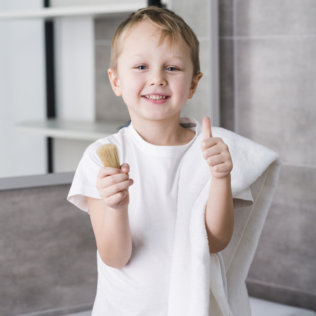 one,gesturing,innocence,indoors,adorable,positivity,innocent,showing,shaver,fluffy,little,shoulder,shaving,casual,front,childhood,standing,smiling,pretty,equipment,fur,holding,gesture,male,soft,thumb,towel,up,portrait,ok,life,bathroom,boy,person,white,sign,child,kid,happy,smile,cute,brush,home,hand,people