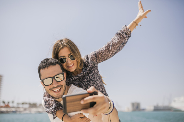 people,technology,man,beauty,smile,happy,couple,smartphone,tech,selfie,electric,electronic,womens day,picture,female,together,cellphone,young,back,happy people