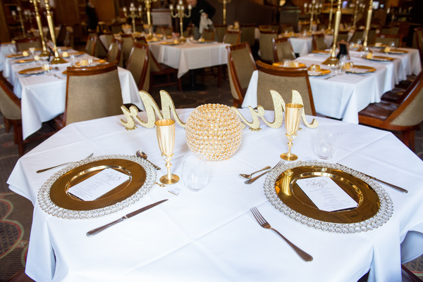 banquet,catering,chairs,cutlery,decoration,dining,dinner,flatware,fork,glass,glass items,gold,indoors,knife,luxury,place setting,plates,reception,restaurant,silverware,table,table setting,tablecloth,tableware