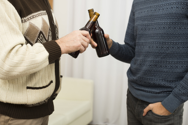man,beer,room,white,bottle,drink,curtain,men,sofa,friend,alcohol,relax,cloth,jeans,together,liquid,sweater,view,male,beverage,rest,bottles,horizontal,anonymous,wear,crop,comfort,leisure,draft,casual,side,pleasure,side view,settee,indoors,faceless,unrecognizable,clanging