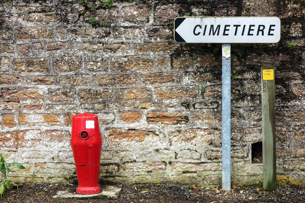 cemetery,post,red,traffic,wall,arrow,blocks,directions,fire hydrant,france,masonry,sign,stone,texture