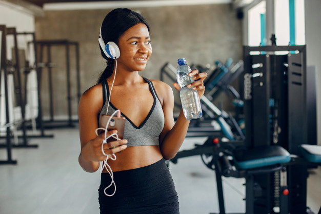 Woman Stretching at the Gym · Free Stock Photo