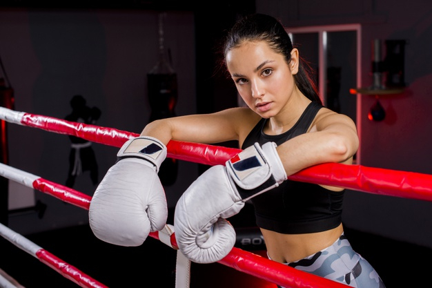 Pretty Muay Thai Female Boxer In Attack Pose. Fitness Young Woman Boxing  Training On Black Background, Closeup Stock Photo, Picture and Royalty Free  Image. Image 191247472.