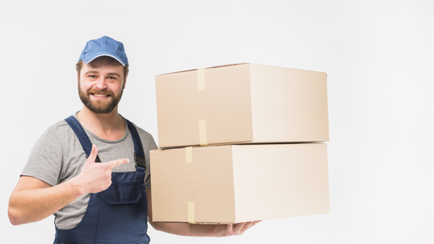 looking at camera,studio shot,showing,carrying,overall,brunette,cheerful,casual,handsome,friendly,stack,standing,looking,pointing,big,smiling,occupation,horizontal,parcel,shot,adult,holding,courier,guy,carton,delivery man,gesture,male,positive,cardboard,packaging box,order,holding hands,background white,boxes,professional,uniform,young,light background,studio,cap,package,finger,service,background blue,beard,worker,job,person,white,clothes,happy,white background,delivery,blue,box,man,camera,light,hand,blue background,background