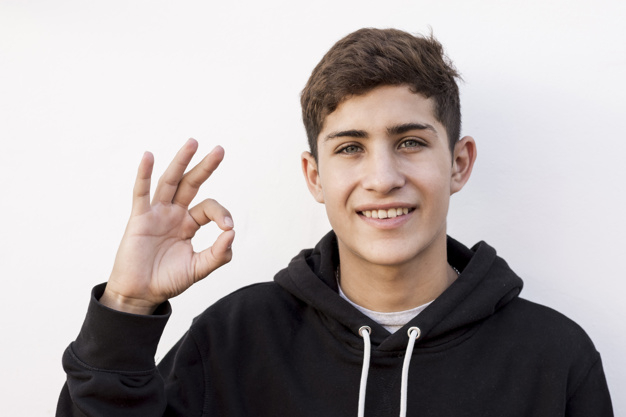 waistup,one,gesturing,showing,satisfied,joyful,confident,cheerful,teenage,handsome,front,looking,smiling,look,guy,gesture,joy,male,positive,emotions,portrait,expression,happiness,ok,show,funny,symbol,fun,teenager,boy,person,backdrop,white,sign,human,happy,smile,camera,people,background