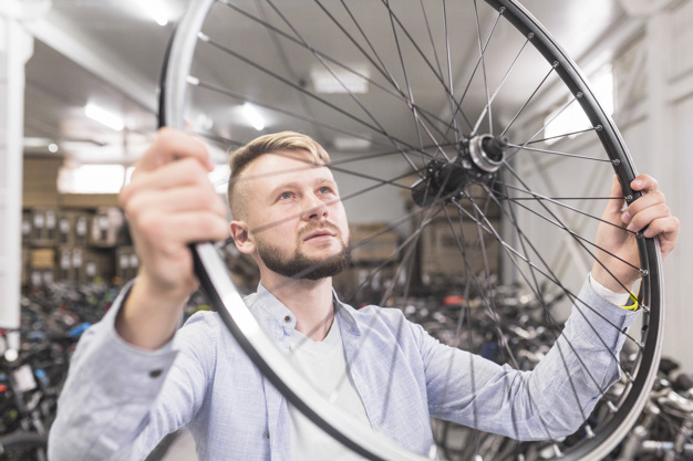 business,people,circle,light,man,sport,shop,bike,human,bicycle,person,business people,store,business man,round,wheel,tire,stand,youth