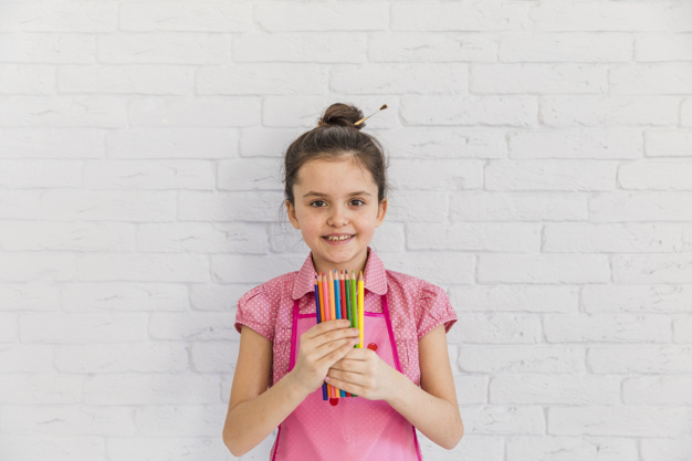 waistup,one,innocence,indoors,closeup,against,brickwall,multicolored,little,casual,front,hold,childhood,colored,standing,artwork,smiling,pencils,holding,hobby,artistic,portrait,apron,happiness,artist,female,craft,creativity,brick,creative,person,white,pencil,colorful,kid,wall,happy,smile,color,art,cute,home,girl,hand,people