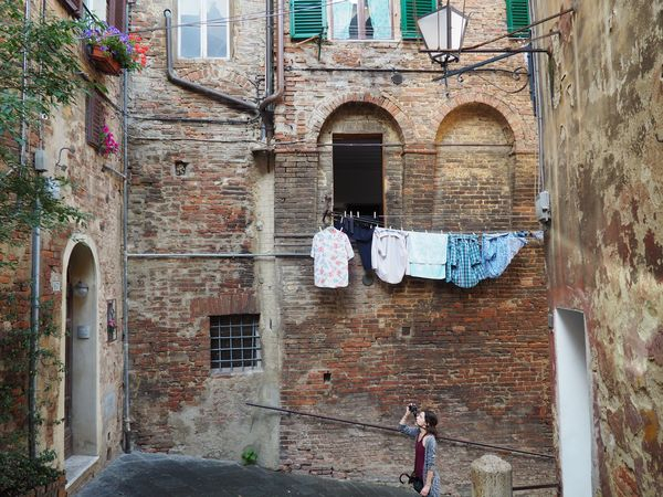buildings,people,clothes,suits,plastic,hanging,shipping,commerce,sales,building,architecture,monastery,church,old,history,city,tower,house,travel,landmark,europe,tourism,religious residence,religion,historical,stone,ancient,historic,sky,cathedral,residence,town,monument,fortress,christian,exterior