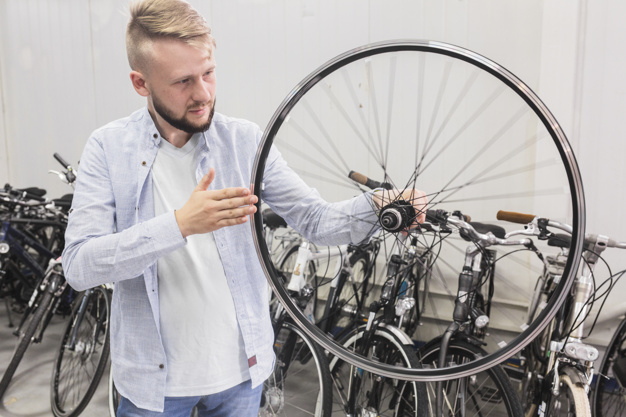 business,people,circle,man,sport,shop,bike,human,bicycle,person,business people,store,business man,round,wheel,tire,stand,youth,transportation