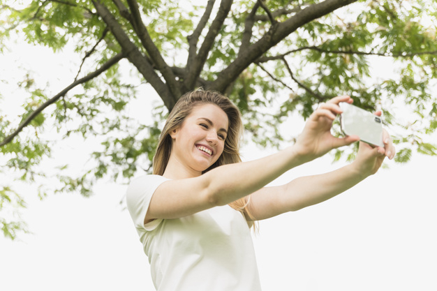 tree,wood,summer,phone,girl,mobile,smile,happy,garden,digital,smartphone,park,natural,mobile phone,teenager,connection,online,lady,selfie,cloth,young,walk,happiness,gadget,device,lifestyle,positive,memory,shooting,horizontal,smiling,wear,outdoors,leisure,casual,cheerful,pleasure,showing,near,using,taking,toothy,from,from below,selfieon,toothy smile