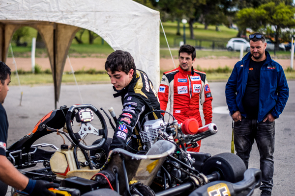 wheel,vehicle,uniform,track,tent,squad,sport,speed,road,rider,racing,racer,race,people,outdoors,men,kart,high speed,helmet,fast,extreme,driving,driver,drive,cyclist,competition,championship,birel,biker,bike,action